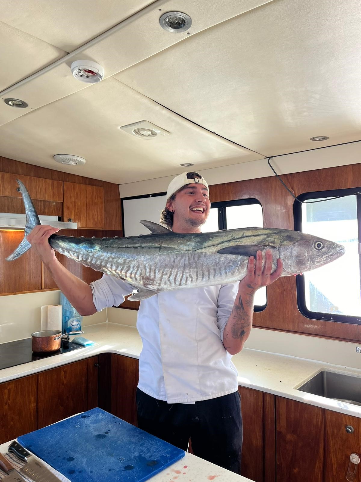 Onboard chef preparing Spanish Mackerel New chef preparing Spanish Mackerel